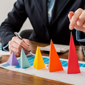 /img/blog/front-view-businessman-with-colorful-cones-representing-growth.jpg